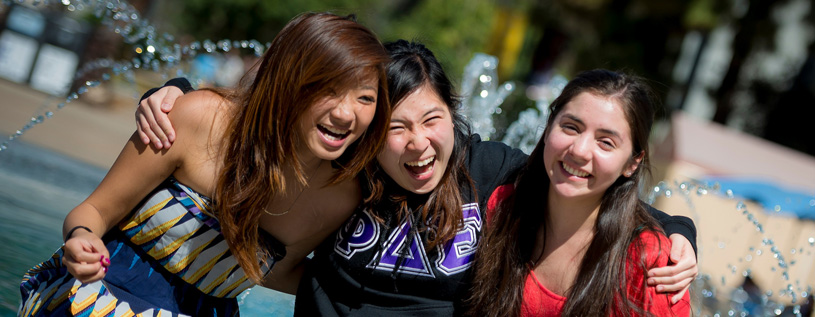 Photo of three students laughing 