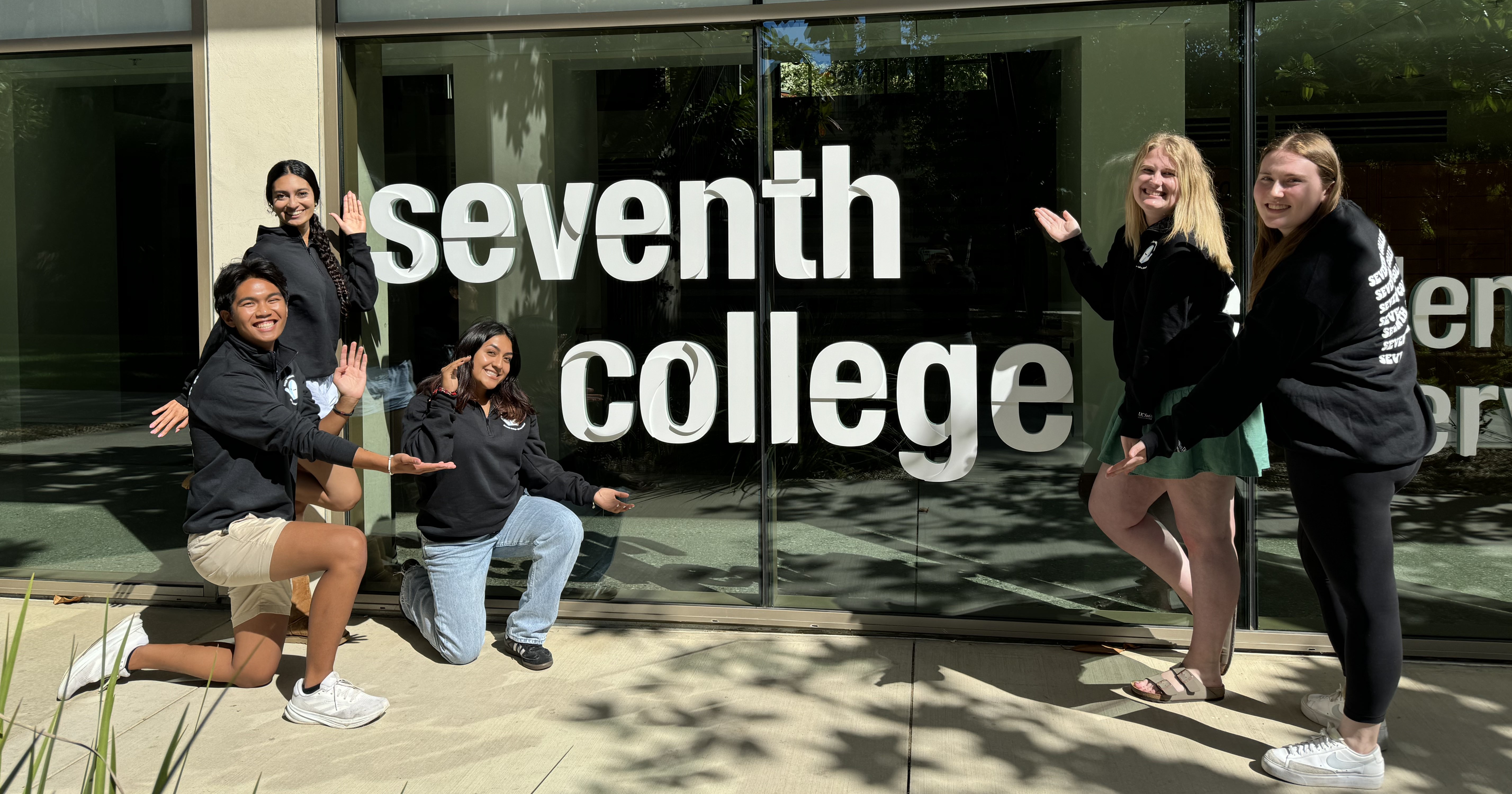 Seventh College Orientation students & staff standing around Seventh College building sign